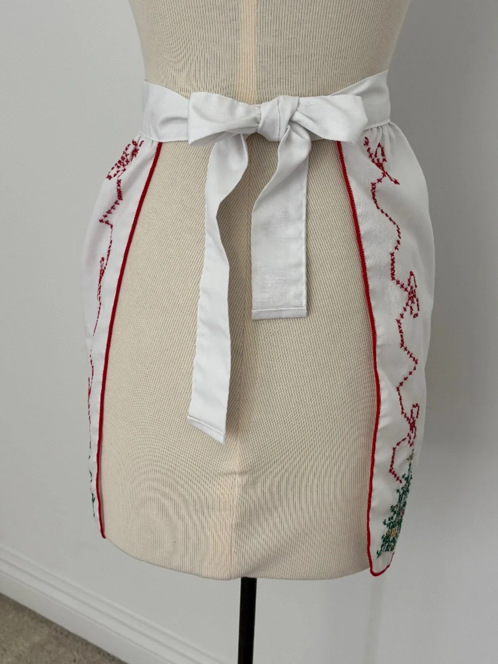 Vintage white half apron featuring hand-stitched cross-stitch Christmas trees
